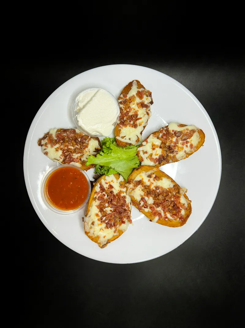 Loaded potato skins with cheese and bacon at Macarena's Kitchen
